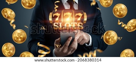 Online casino, smartphone with slot machine with jackpot and gold coins. Online Slots, Lucky Seven 777, Dark Gold Style. Luck concept, gambling, jackpot, banner Royalty-Free Stock Photo #2068380314