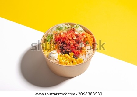 a salad poke with yellow background, asian hawaiian food, carrot, healthy food, corn and jicama, no people Royalty-Free Stock Photo #2068383539