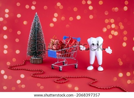 cartoon model of a tooth, a cart with gift boxes, a Christmas tree on a red background with a bokeh