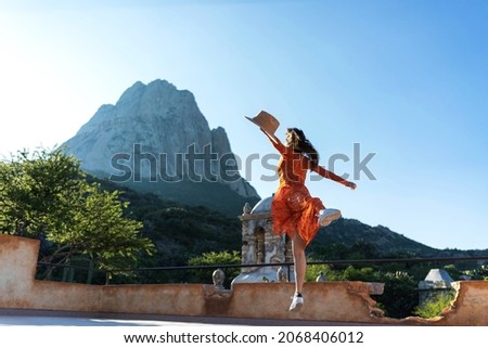 young woman jumping at dawn Royalty-Free Stock Photo #2068406012
