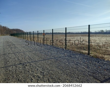 Metal fence green fence, barrage street, autumn.