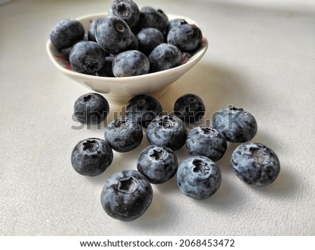 Blueberries in small bowl on gray background.
Blueberry is a flowering plant in the genus Vaccinium, part Cyanococcus