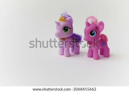 Two little cartoon unicorn toys
