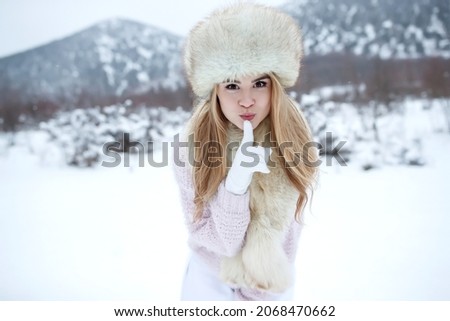 Winter woman in the snow. Beautiful girl in the winter in nature. High quality photo