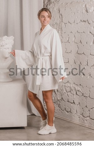 Minimalist studio photos with bohemian background of happy caucasian blonde young woman wearing in white kimono style dress for creating pattern mockup designs and using for web