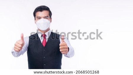 New normal protection flu diseases health care concept. Businessman wear medical protect face mask gesture showing thumbs up symbol ok while standing over isolated white background.