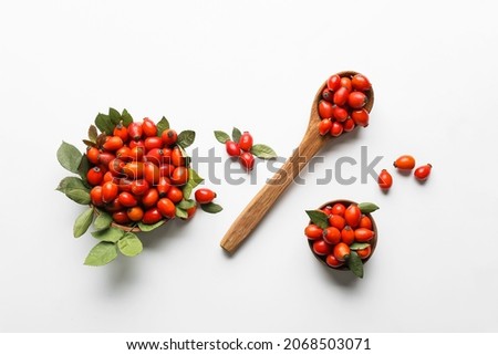 Composition with fresh rose hip berries on white background Royalty-Free Stock Photo #2068503071