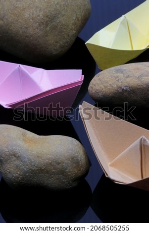 origami colorful paper boat  on dark background