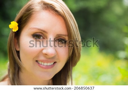 Close up portrait of a cute young woman in field