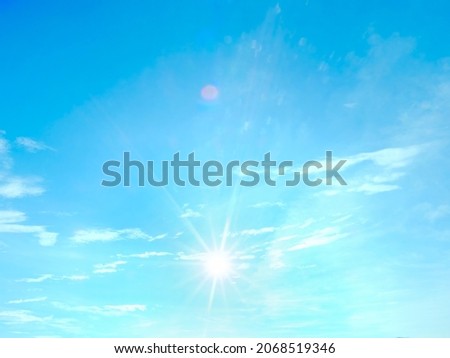 soft sky background with clouds and sun, real photo