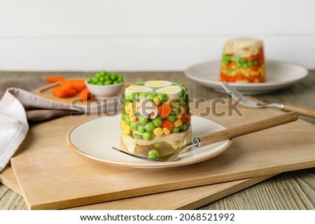 Plate with tasty aspic on table