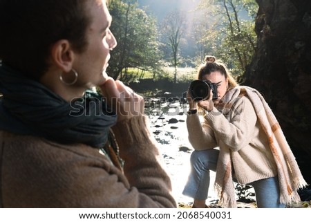 Photographer taking a portrait to a handsome young man