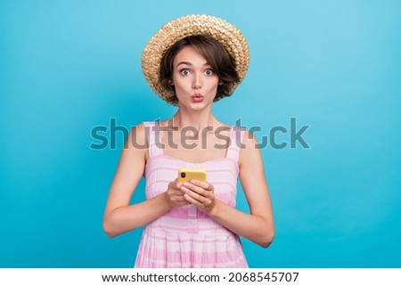 Photo of impressed young blogger lady hold telephone wear hat pink dress isolated on blue color background