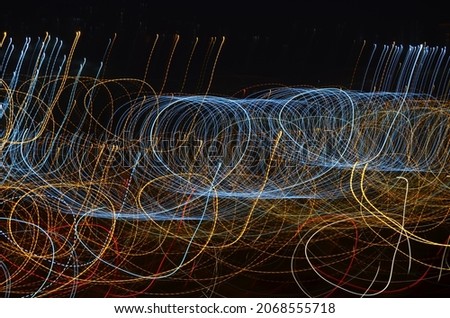 City lights in lines drawn with low shutter speeds at dusk. Can be used as background.