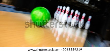 bowling alley with a stack of white pin