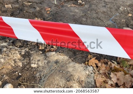Red and White Lines of barrier tape. Red White warning tape pole fencing is protects for No entry, closeup