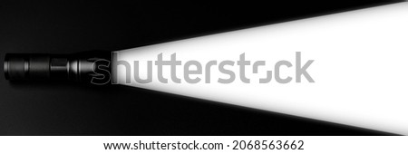 flashlight illuminates a white area on black background. creative ideas innovative free space for business or education design banner