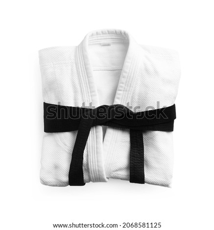 Martial arts uniform with black belt on white background, top view Royalty-Free Stock Photo #2068581125