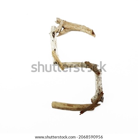 letter S made of dry wood isolated over white background, copy space.