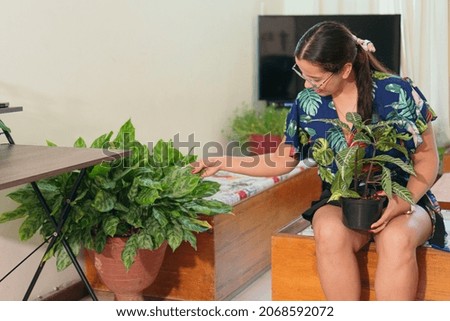 woman with a beautiful plant at home.