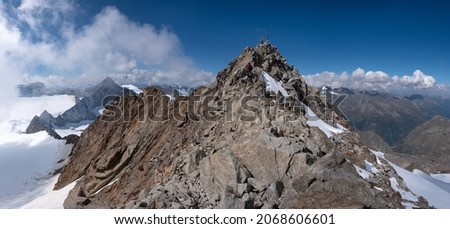 Mountain ridge in Stubai Alps with Wilder Freiger summit. Climbers  on the summit. Border between Austria and Italy in Tyrol Alps.  Royalty-Free Stock Photo #2068606601