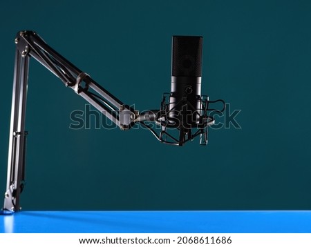Studio microphone as a symbol of audio podcasts. Microphone for conducting audio podcasts. Studio microphone close-up. Concept - professional equipment for podcasting. Radio host device