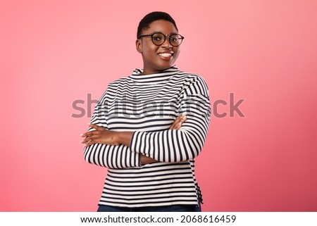 Happy Plus Size Black Woman Wearing Eyeglasses Smiling To Camera Standing Over Pink Background. Cheerful Millennial Female In Eyewear Posing In Studio Royalty-Free Stock Photo #2068616459