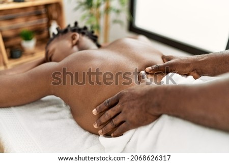 African american woman reciving back massage at the clinic. Royalty-Free Stock Photo #2068626317