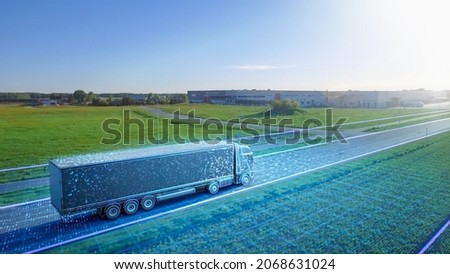 Advanced High-Tech Concept: Big Semi Truck with Cargo Trailer Drives on the Road is Transformed with Graphics Special Effects Into Digitalized Version of Futuristic Autonomous Truck. Aerial Drone Shot Royalty-Free Stock Photo #2068631024