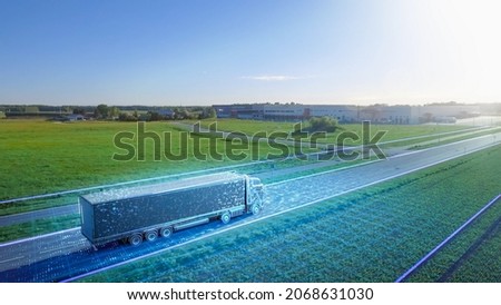 Futuristic High-Tech Concept: Big Semi Truck with Cargo Trailer Drives on the Road is Transformed with Graphics Special Effects Into Digitalized Advanced Autonomous Truck Concept. Aerial Drone Shot Royalty-Free Stock Photo #2068631030
