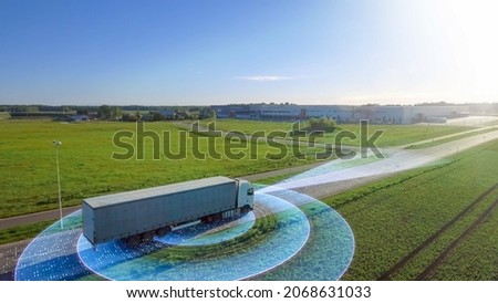 Futuristic High-Tech Concept: Big Semi Truck with Cargo Trailer Drives on the Road is Transformed with Graphics Special Effects Into Digitalized Advanced Autonomous Truck Concept. Aerial Drone Shot Royalty-Free Stock Photo #2068631033