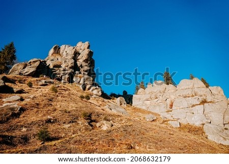 National park with rocks background. Thousand year old fortress of Tustan, archeological and natural monument, Ukraine, Carpathian mountains. Autumn