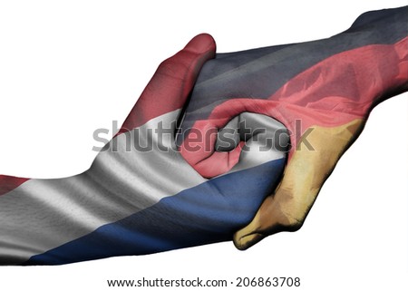 Diplomatic handshake between countries: flags of Netherlands and Germany overprinted the two hands