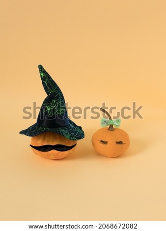 Couple of orange pumpkins. Funny vegetable personages healthy food concept.