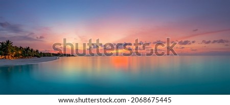 Beautiful panoramic sunset tropical paradise beach. Tranquil summer vacation or holiday landscape. Tropical sunset beach seaside palm calm sea panorama exotic nature view inspirational seascape scenic Royalty-Free Stock Photo #2068675445