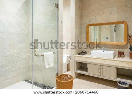 Modern interior of bathroom in luxury contemporary apartment. White sink and toilet. Shower. Royalty-Free Stock Photo #2068714460
