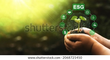 Using technology of renewable resource to reduce pollution. Hands holding grow plant with network connection and ESG icons. Environment social and 
governance in sustainable and ethical business. Royalty-Free Stock Photo #2068721450