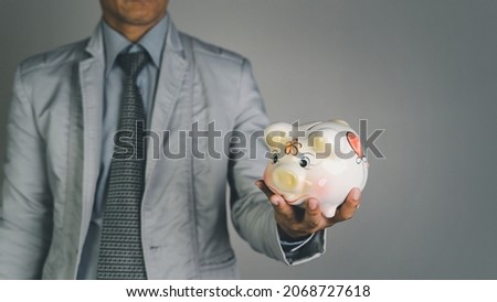 Banner of a Businessman hand holding piggy bank, Concept financial business investment, business, finance, investment, financial planning.