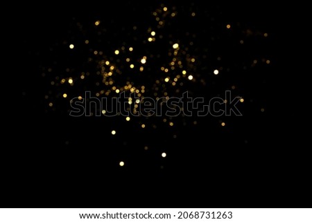 Golden blurred bokeh lights on black background. Glitter sparkle stars for celebrate. Overlay for your design Royalty-Free Stock Photo #2068731263