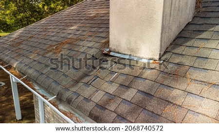 Roof and shingles damaged from water leak Royalty-Free Stock Photo #2068740572