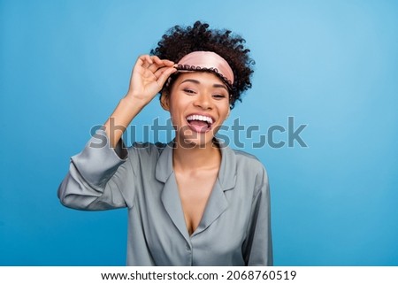 Photo of young cheerful afro girl good mood laughing blindfold awakening isolated over blue color background
