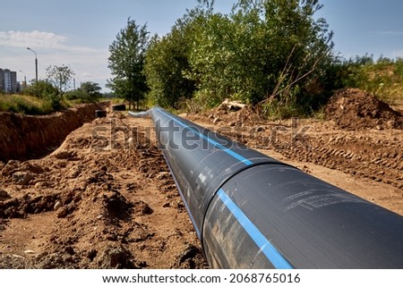 Civil engineering. The welded lash of the water pipe lies on the ground Royalty-Free Stock Photo #2068765016
