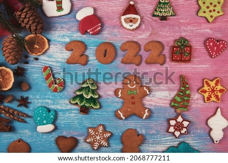 Gingerbread cookies for new 2022 year on wooden background, xmas theme Royalty-Free Stock Photo #2068777211