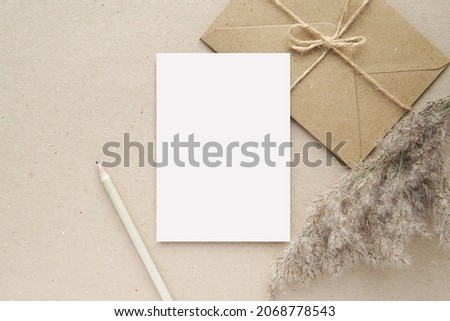 Notecard, postcard, greeting card mockup, brown envelope, pampas grass, blank letter paper or note paper for design or text presentation. Royalty-Free Stock Photo #2068778543