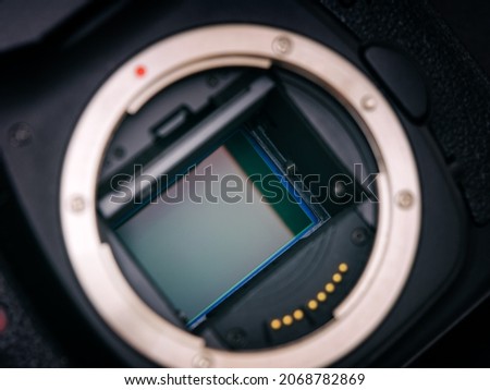 A shot of the CMOS sensor inside of a DSLR camera. Low key. Close up. Royalty-Free Stock Photo #2068782869