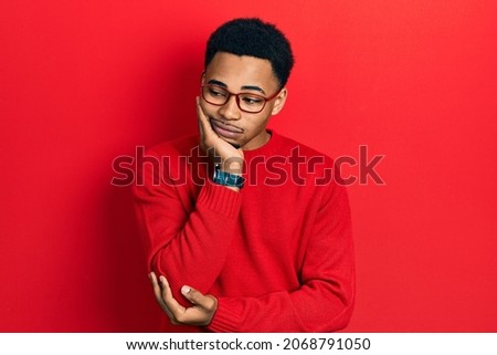 Young african american man wearing casual clothes and glasses thinking looking tired and bored with depression problems with crossed arms. 