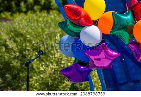 Preparation for the festive children's concert at school and in the pre-school institution of education. Microphone and inflatable balls on stage before a concert.
