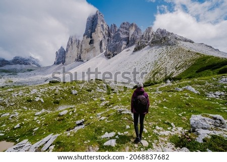 Tre Cime di Lavaredo peaks or Drei Zinnen at sunset, Dobbiaco Toblach, Trentino -Alto Adige or South Tyrol, Italy. Europe Alps. Asian woman hiking in the mountains Royalty-Free Stock Photo #2068837682