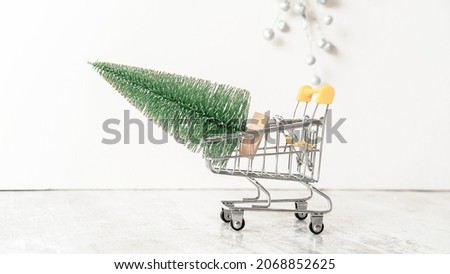 a small green Christmas tree figurine in a supermarket cart 
