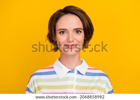Photo of cute young brunette lady wear sriped t-shirt isolated on yellow color background